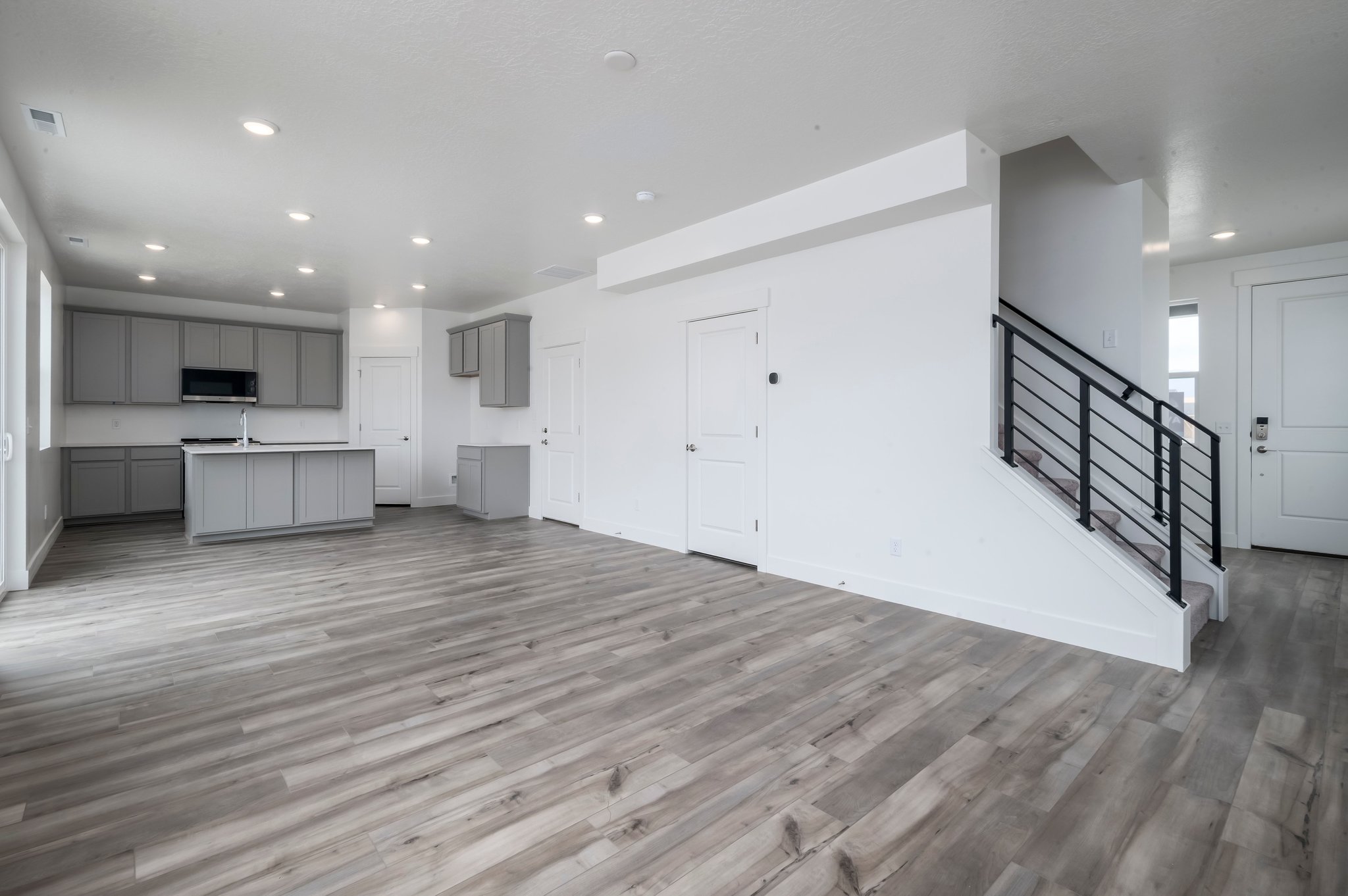 A room with white walls and wood floors.