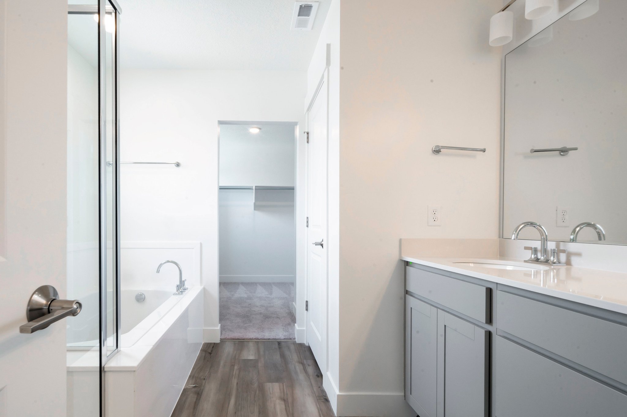 A bathroom with a tub sink and a shower.