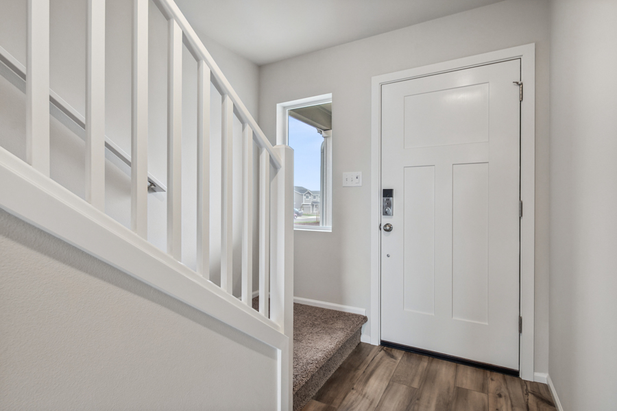 A white staircase with a mirror.