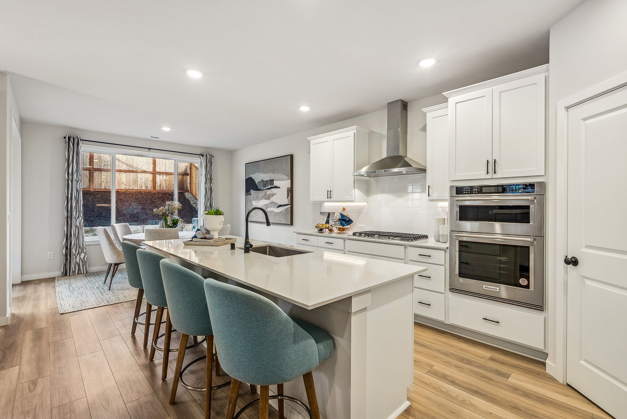A kitchen with white cabinets.