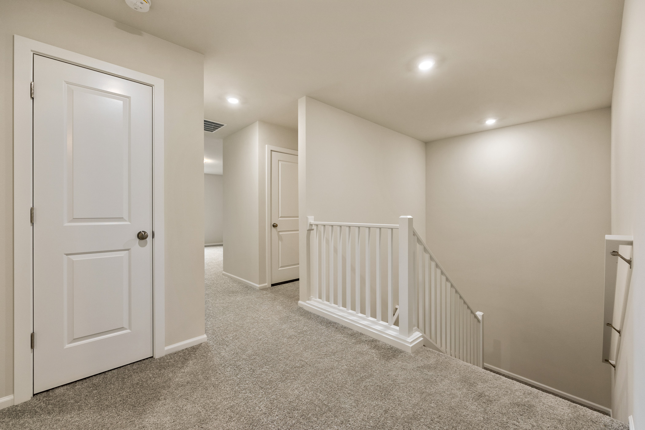 A hallway with white doors.