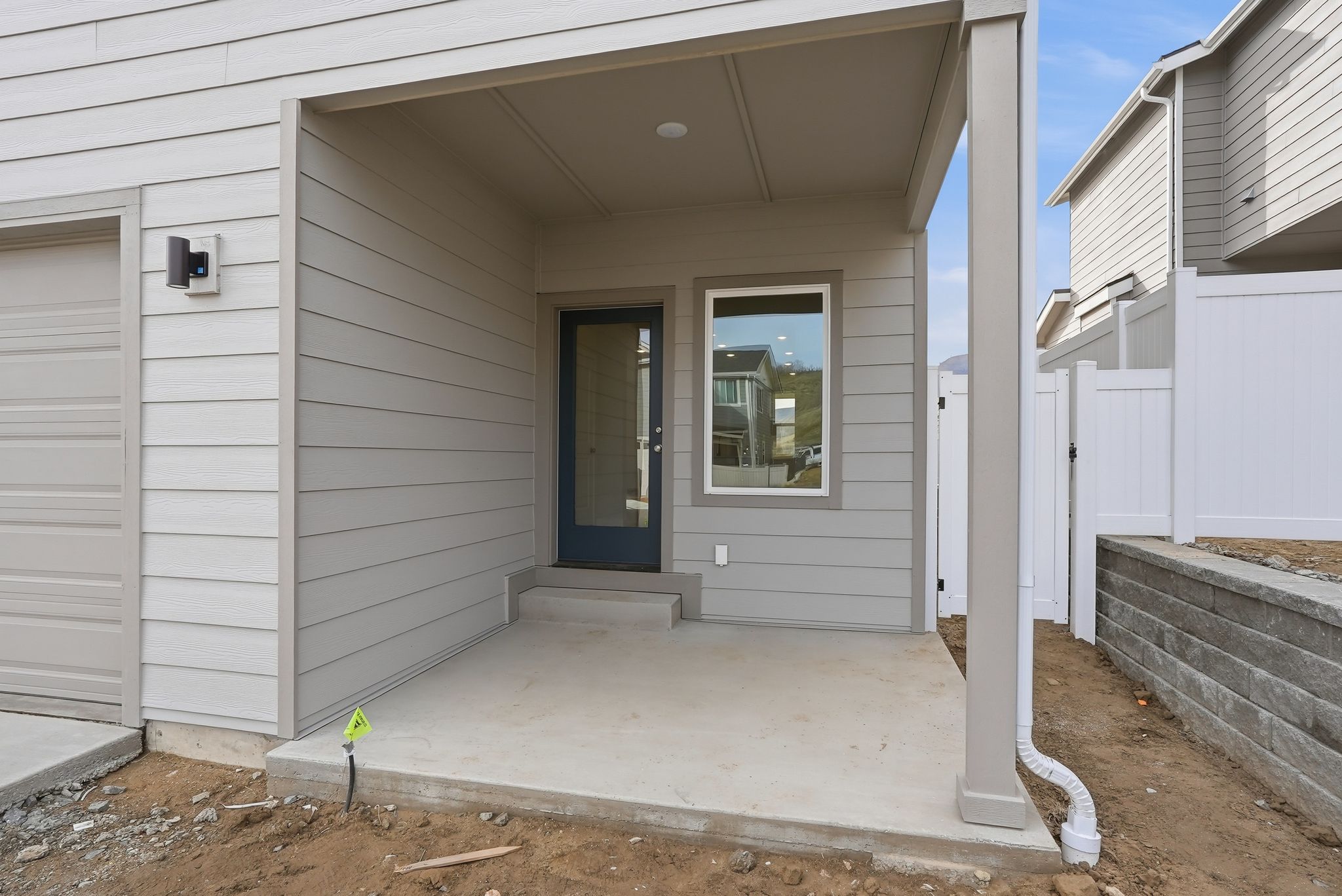 A white house with a garage.