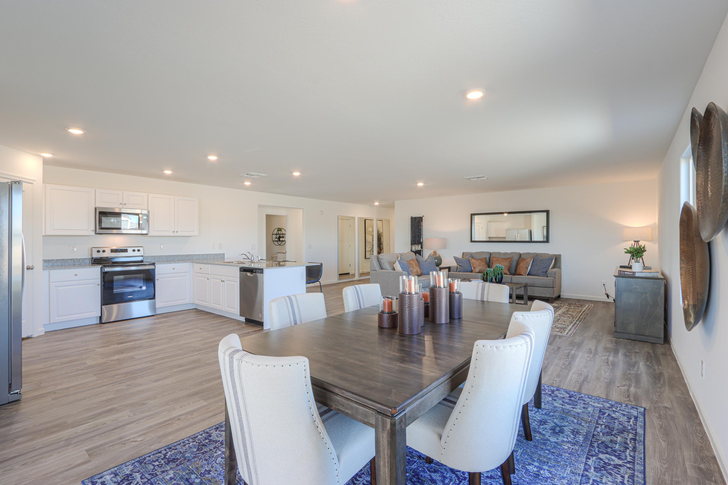 A large kitchen with a dining table.