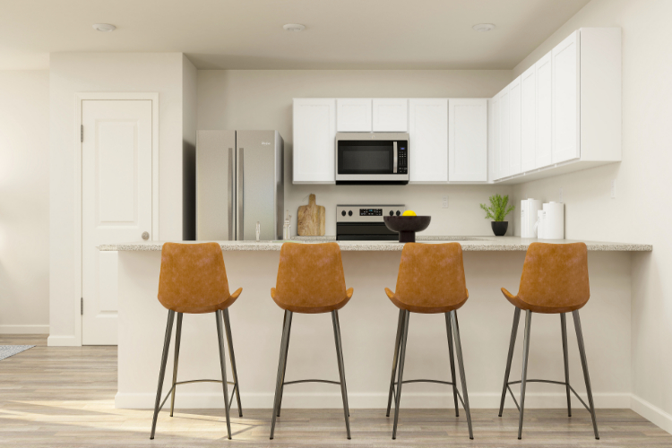 A kitchen with a table and chairs.