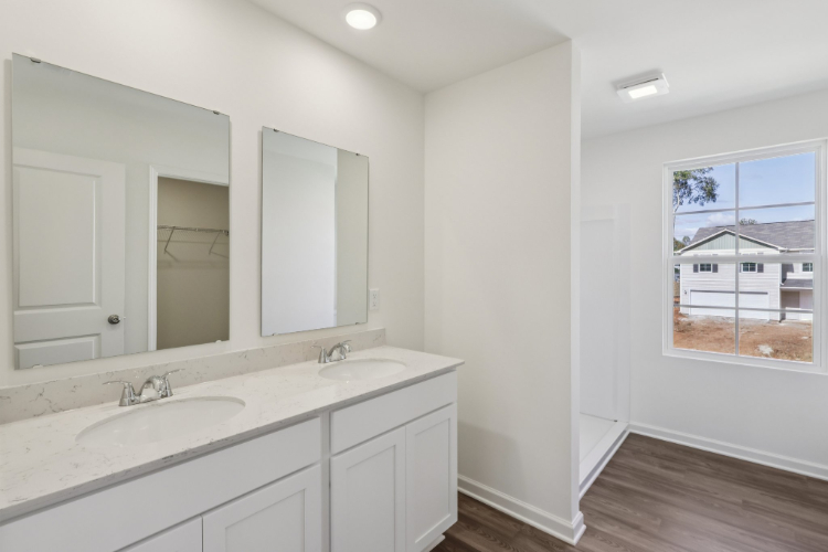 A bathroom with a large mirror.
