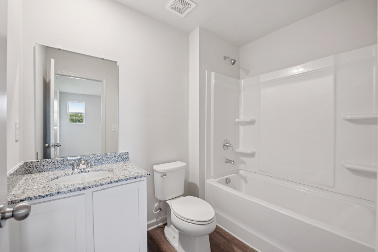 A bathroom with a tub toilet and sink.