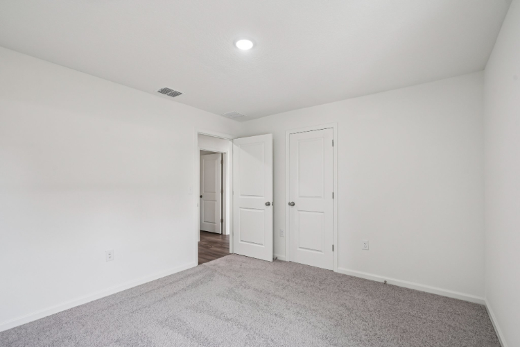 A hallway with white doors.