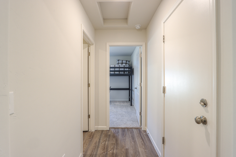 A hallway with white doors.