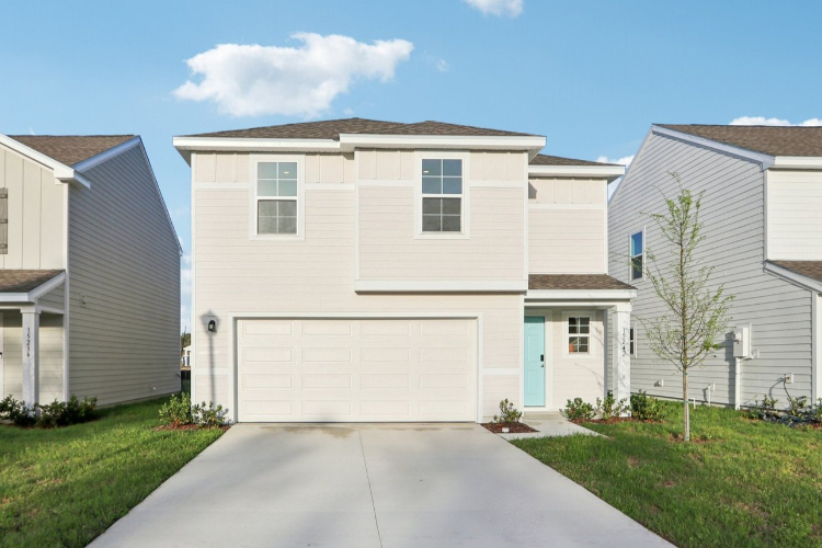A white garage in a neighborhood.