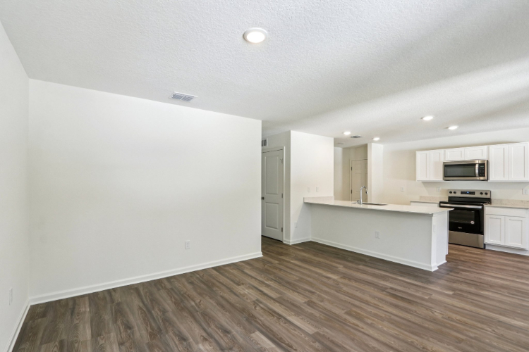 A kitchen with white cabinets.