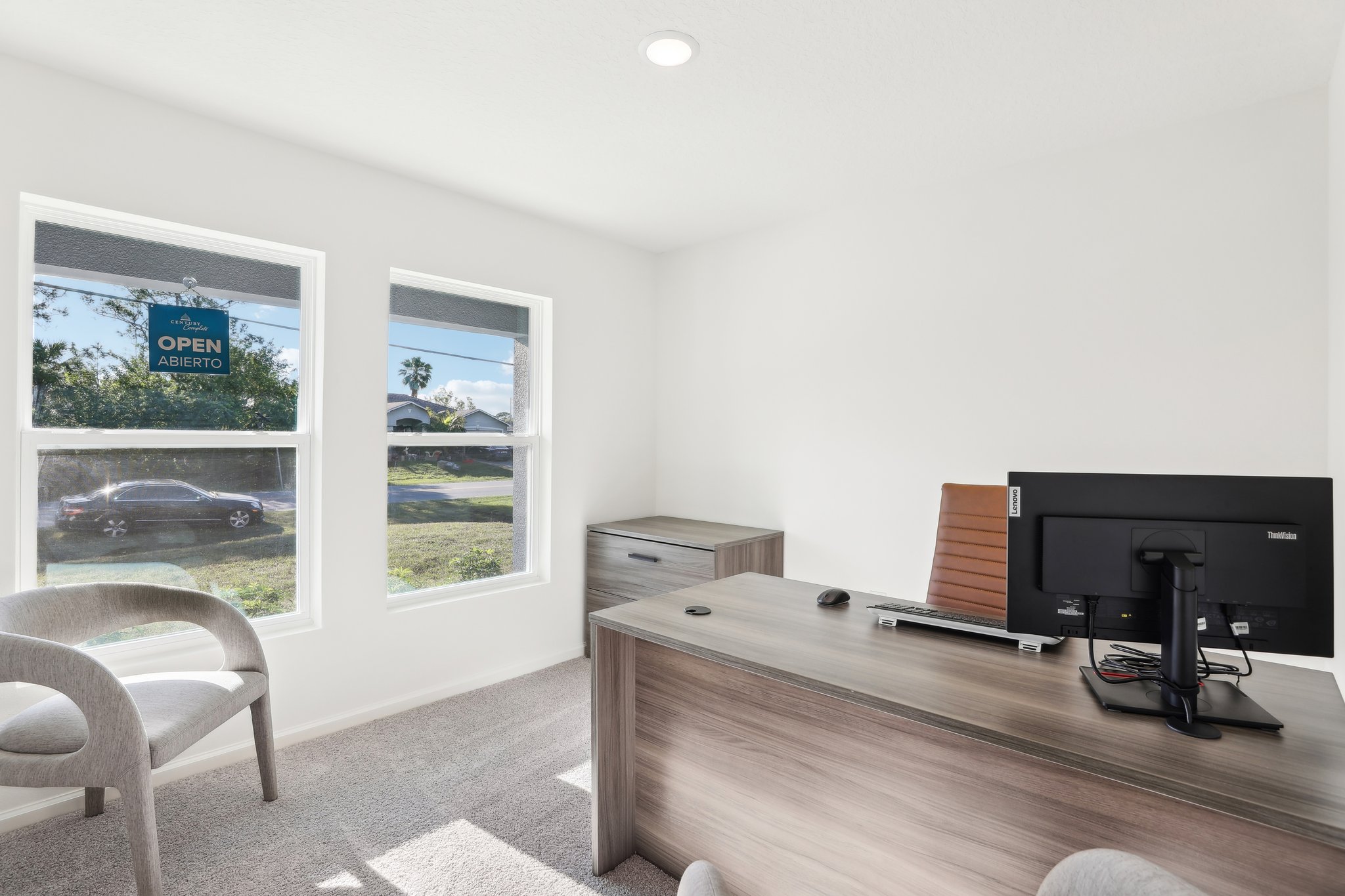 A room with a desk and a tv.