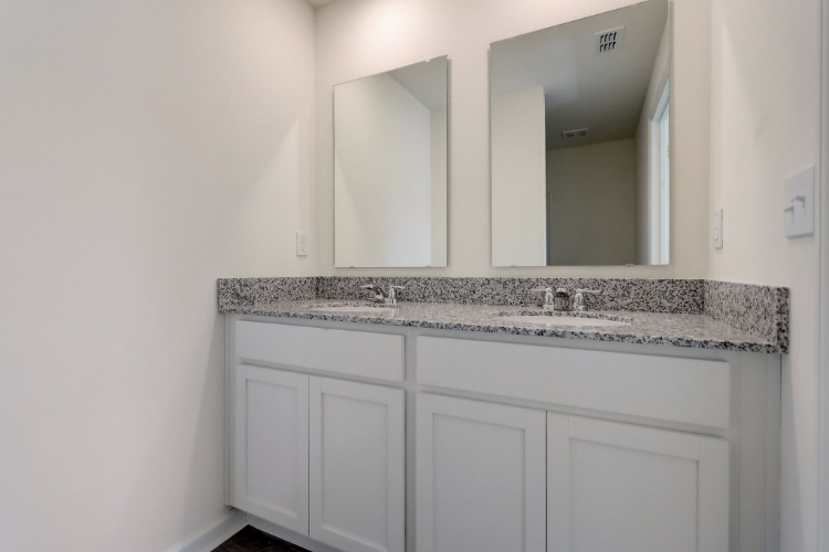 A bathroom with a marble countertop.