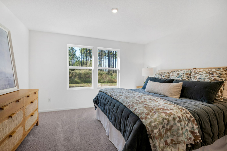 A bedroom with a bed and a window.