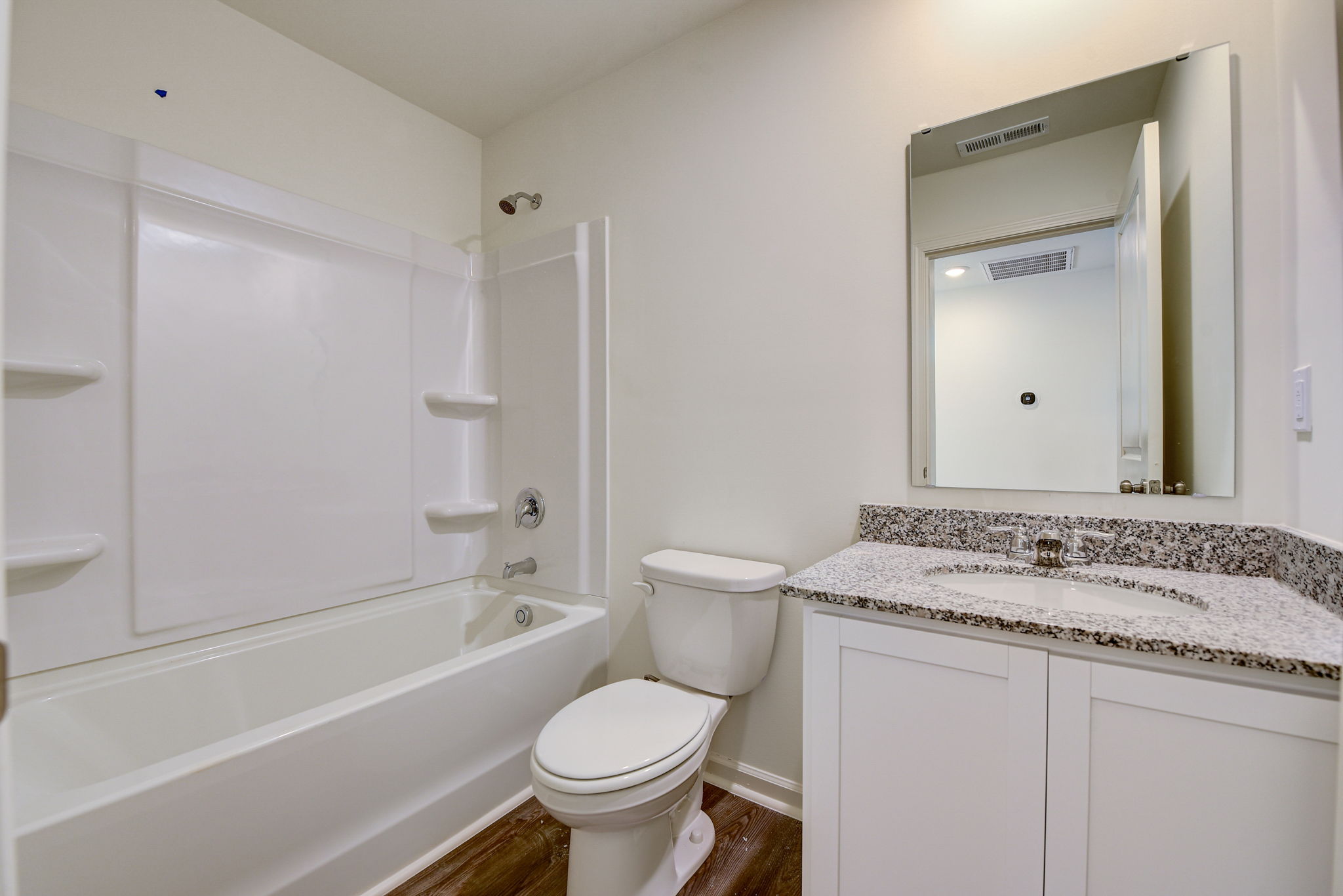 A bathroom with a tub toilet and sink.